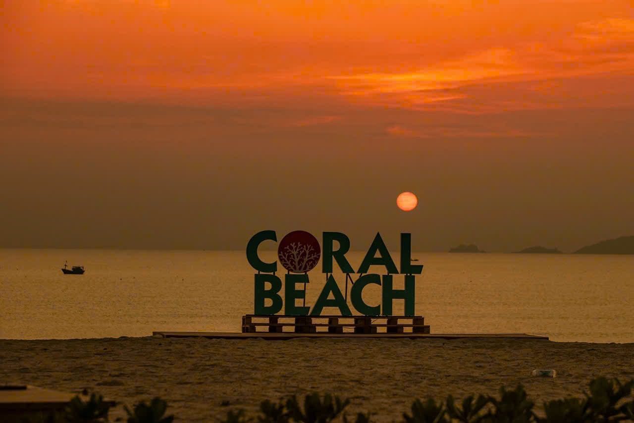 Coral Beach sign at sunrise with an orange sky